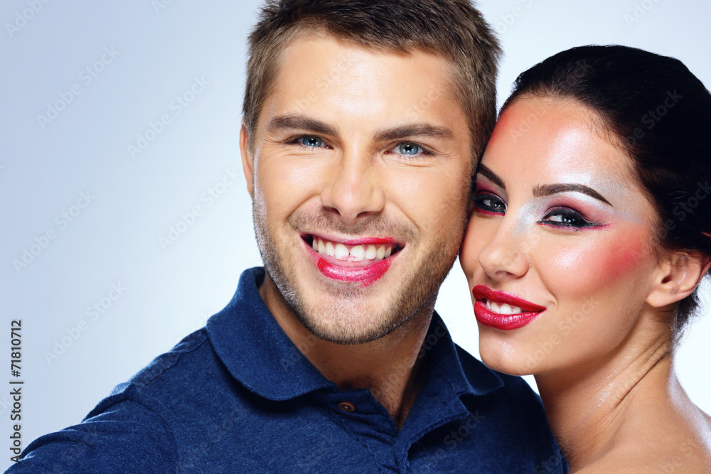 Portrait of a happy beautiful couple on blue background Portrait of a happy beautiful couple on blue background