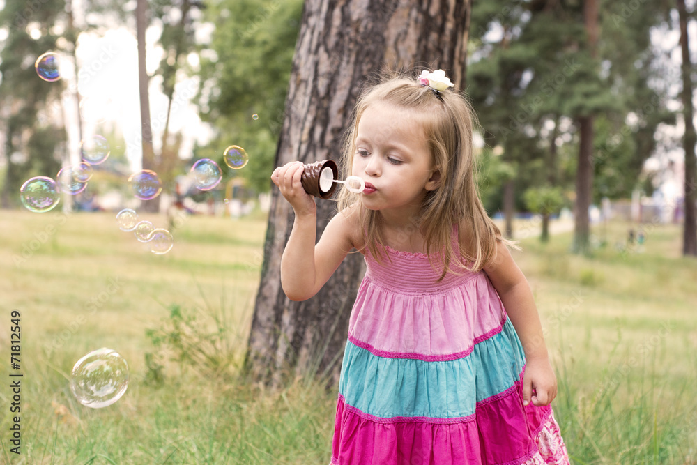 Little girl blowing soap bubbles Little girl blowing soap bubbles