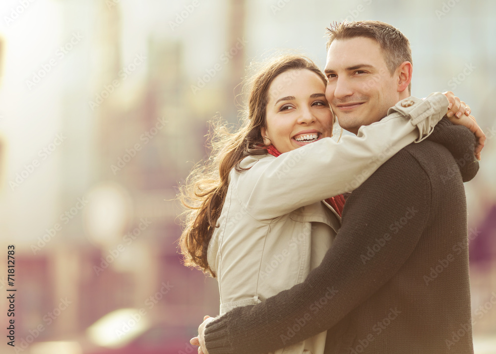 Young couple embracing in the sity street and looking happy. Young couple embracing in the sity street and looking happy.