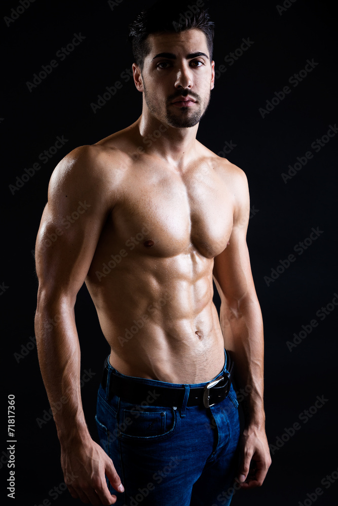 Beautiful and muscular man in dark background. Beautiful and muscular man in dark background.