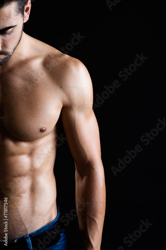 Beautiful and muscular man in dark background.