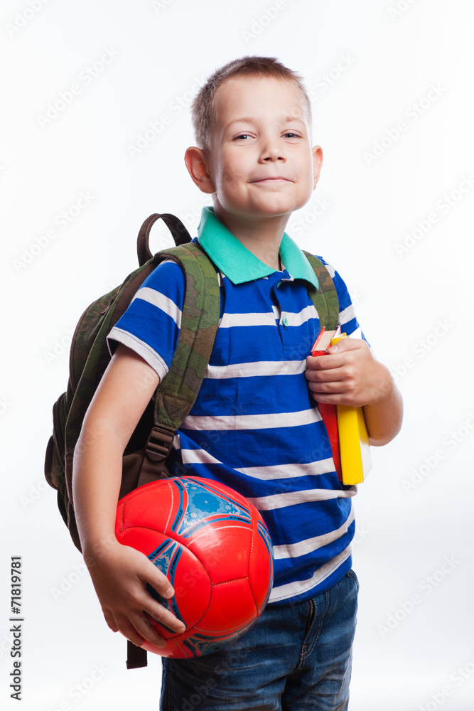 Happy schoolboy with backpack, ball and books Happy schoolboy with backpack, ball and books