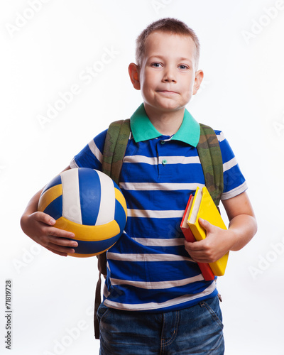 Happy schoolboy with backpack and soccer ball