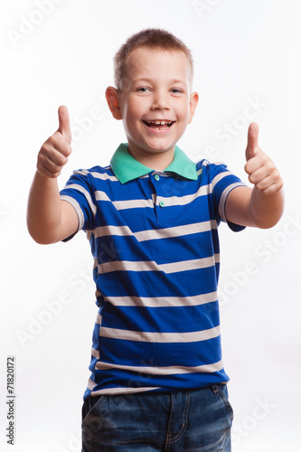 Portrait of happy boy showing thumbs up gesture,