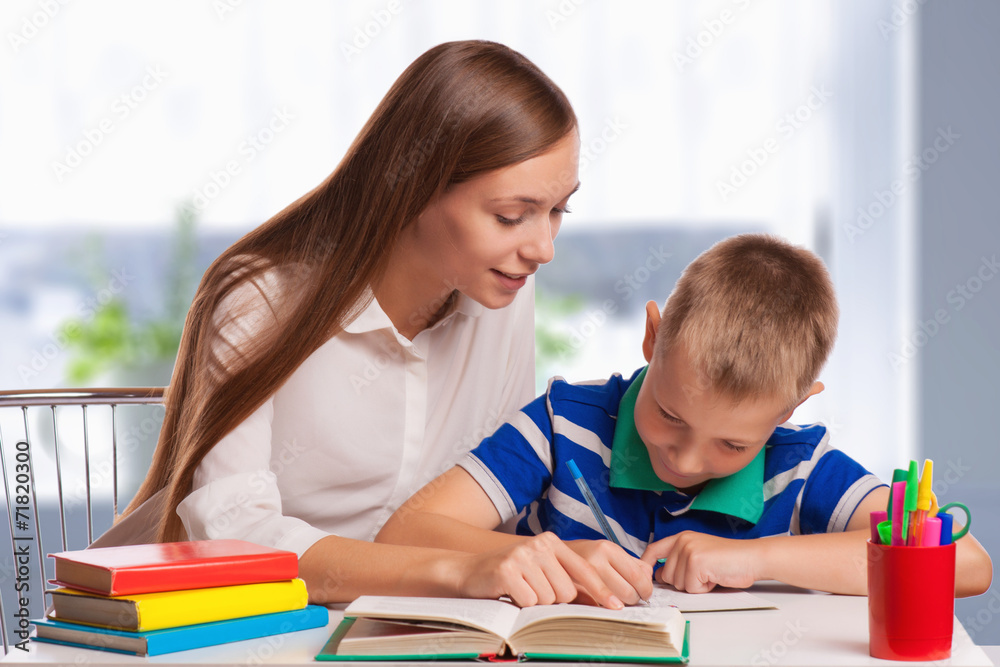 Mother Helping Son With Homework At Table Mother Helping Son With Homework At Table