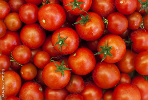 Cherry tomatoes and basil on wooden background