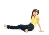 Pretty little girl lying on the floor in jeans