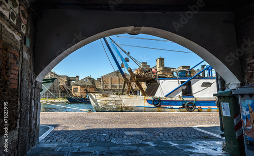 View to harbour from house arch, Chioggia,Italy.