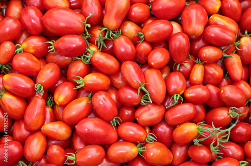 Background of the plurality of oval red tomatoes