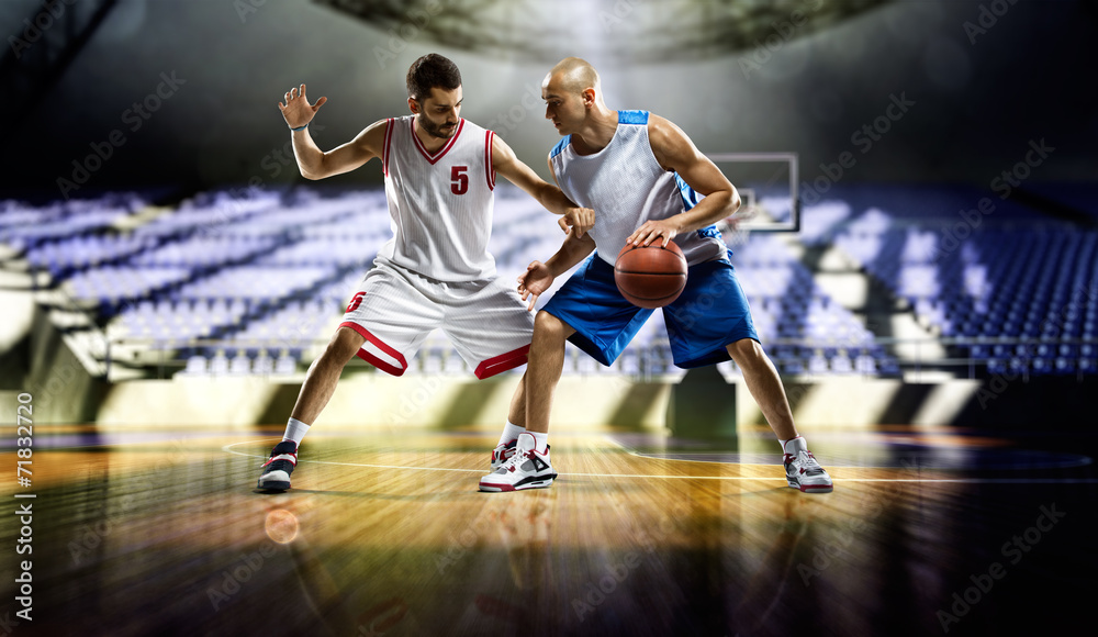 Two basketball players in action in the gym Two basketball players in action in the gym