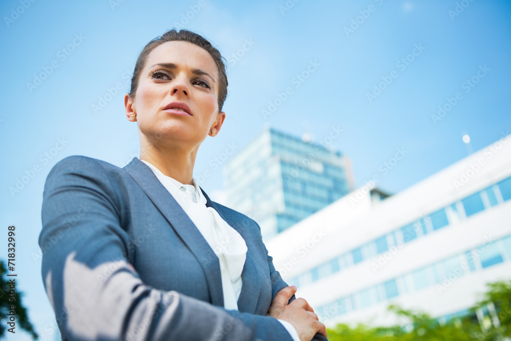 Portrait of serious business woman in front of office building Portrait of serious business woman in front of office building