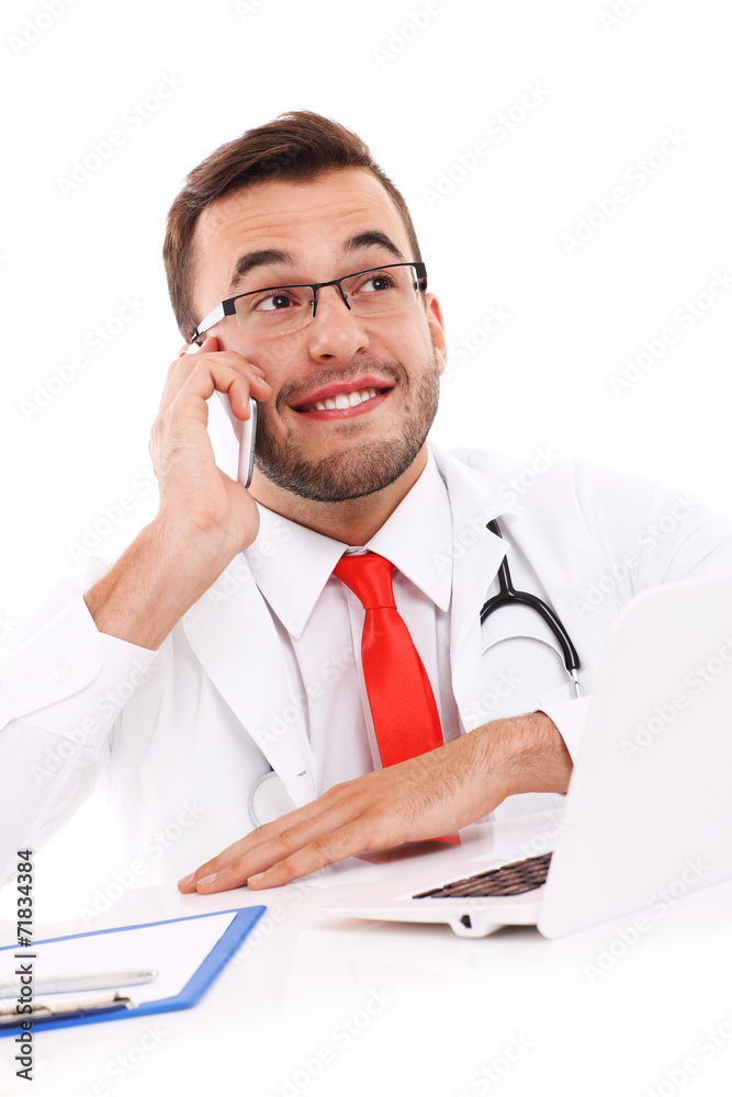 Doctor talking on the phone in the office Doctor talking on the phone in the office