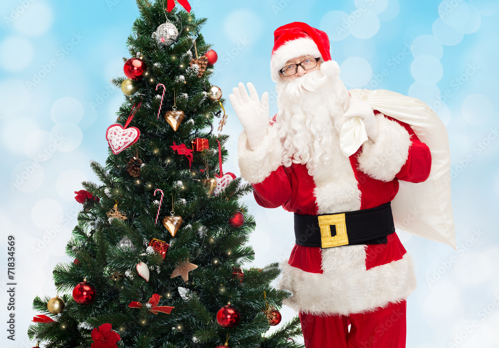 santa claus with bag and christmas tree