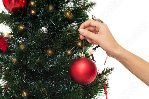 close up of woman with christmas tree decoration