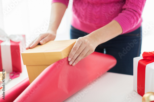 close up of woman decorating christmas presents