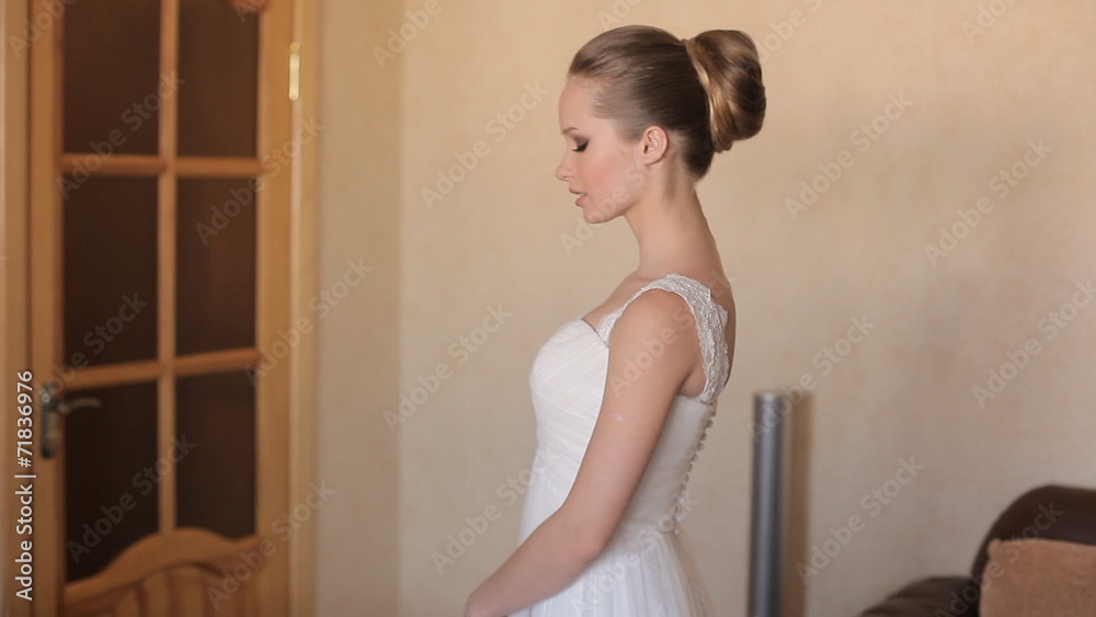 Beautiful elegant bride standing in her wedding dress Beautiful elegant bride standing in her wedding dress
