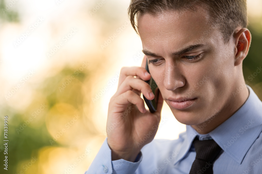 businessman talking over cellphone businessman talking over cellphone