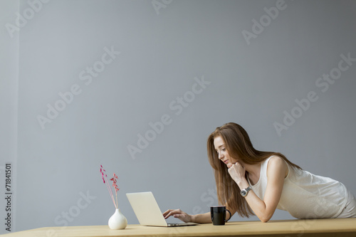 Young woman with laptop in ...