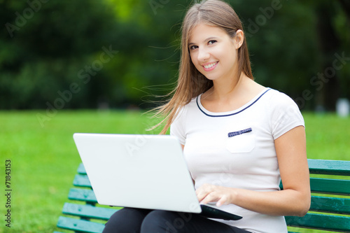 Woman using a laptop computer outdoors