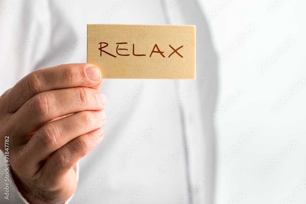 Man Holding Small Piece Wood with Relax Text Man Holding Small Piece Wood with Relax Text