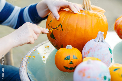 Hollowing out a pumpkin to prepare halloween lantern