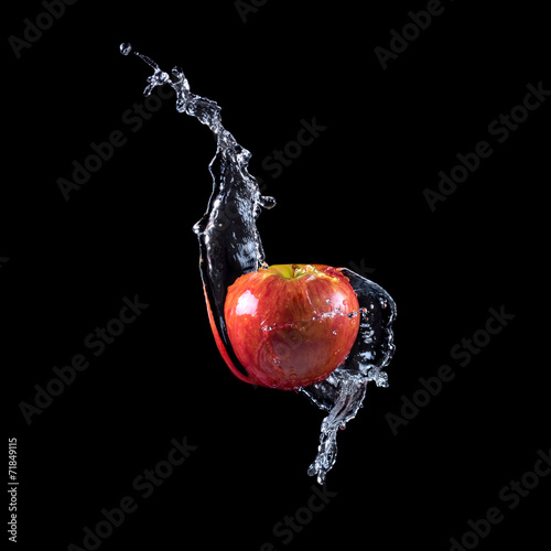 Red apple splashing into water