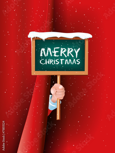 Weihnachtsmann hält Schild Merry Christmas hinter Vorhang