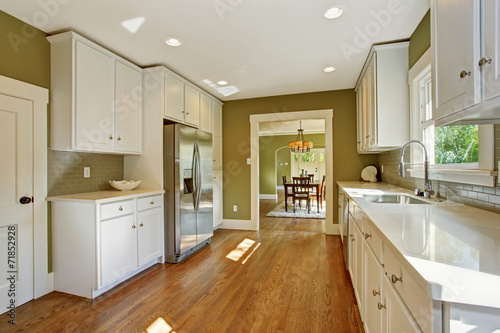 Green kitchen room with white storage combination