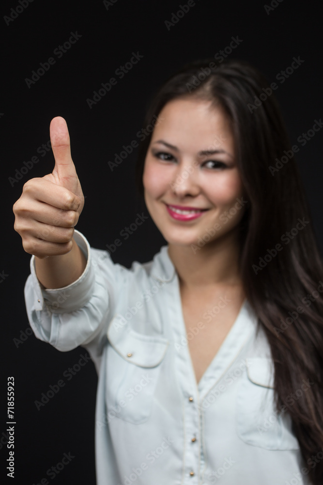 young asian girl making the thumb up sign young asian girl making the thumb up sign
