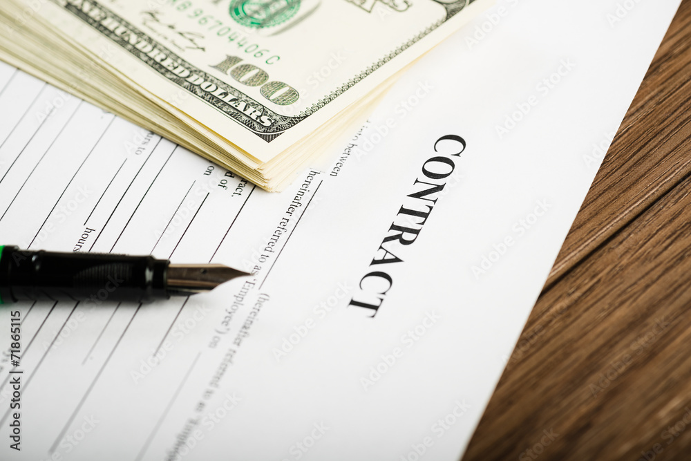 Pen on the contract papers and us dollars Pen on the contract papers and us dollars