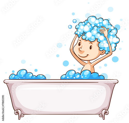 A young boy taking a bath