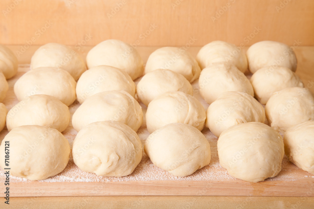 Small balls of dough with flour for pizza or cakes and scones. S Small balls of dough with flour for pizza or cakes and scones. S