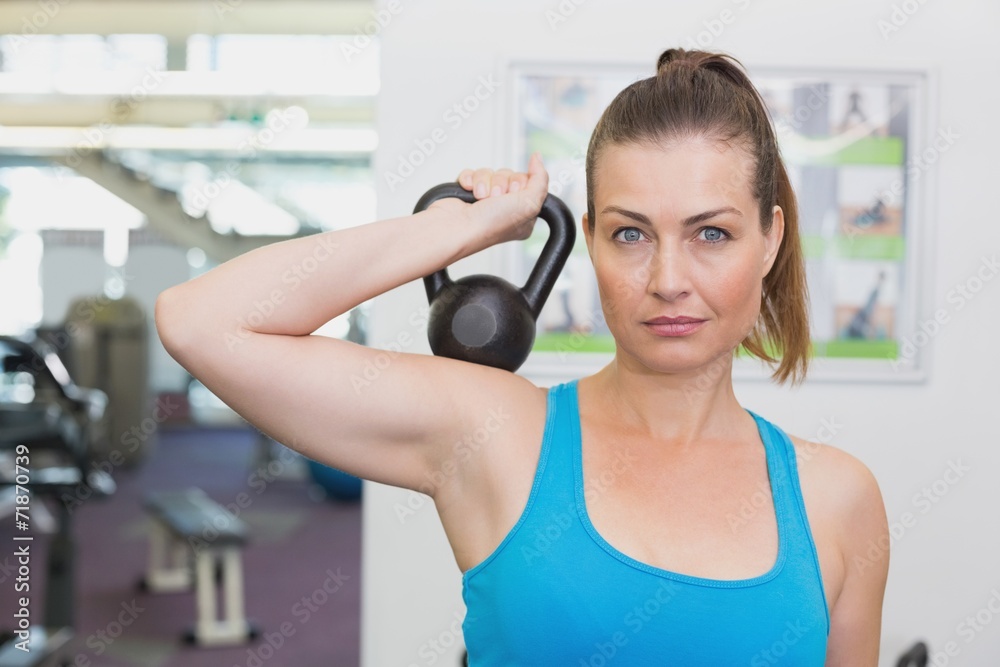 Fit brunette working out with kettlebell Fit brunette working out with kettlebell