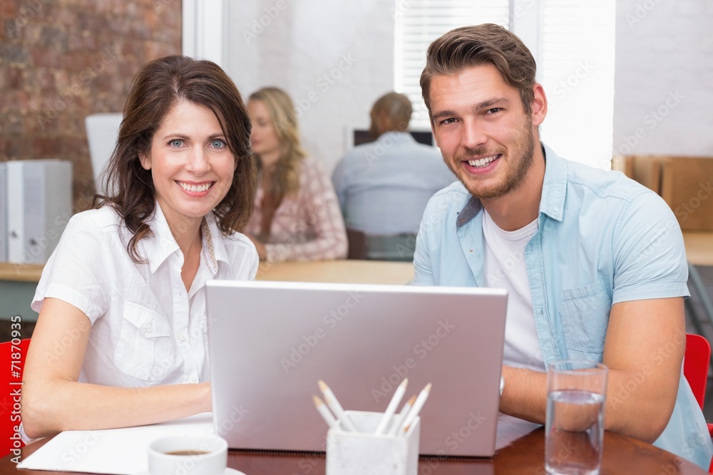 Smiling business people working together with laptop Smiling business people working together with laptop