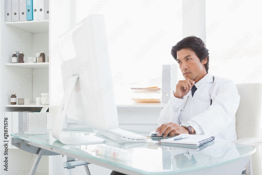 Serious doctor using the computer