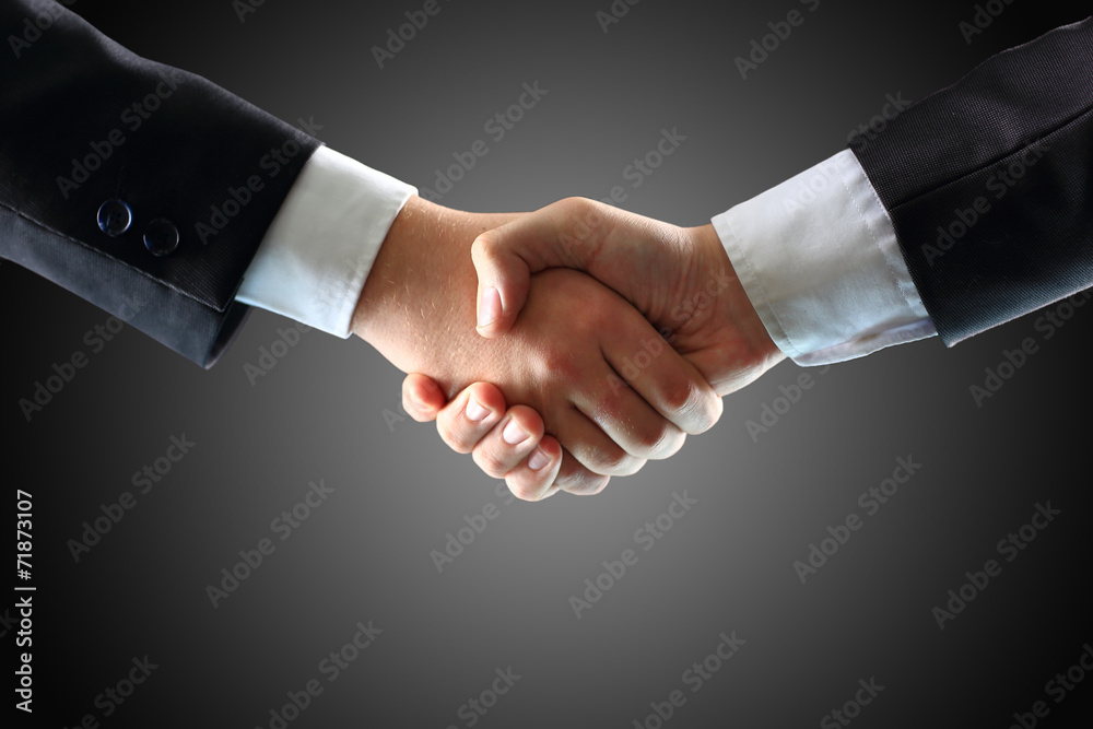 Handshake - Hand holding on black background Handshake - Hand holding on black background