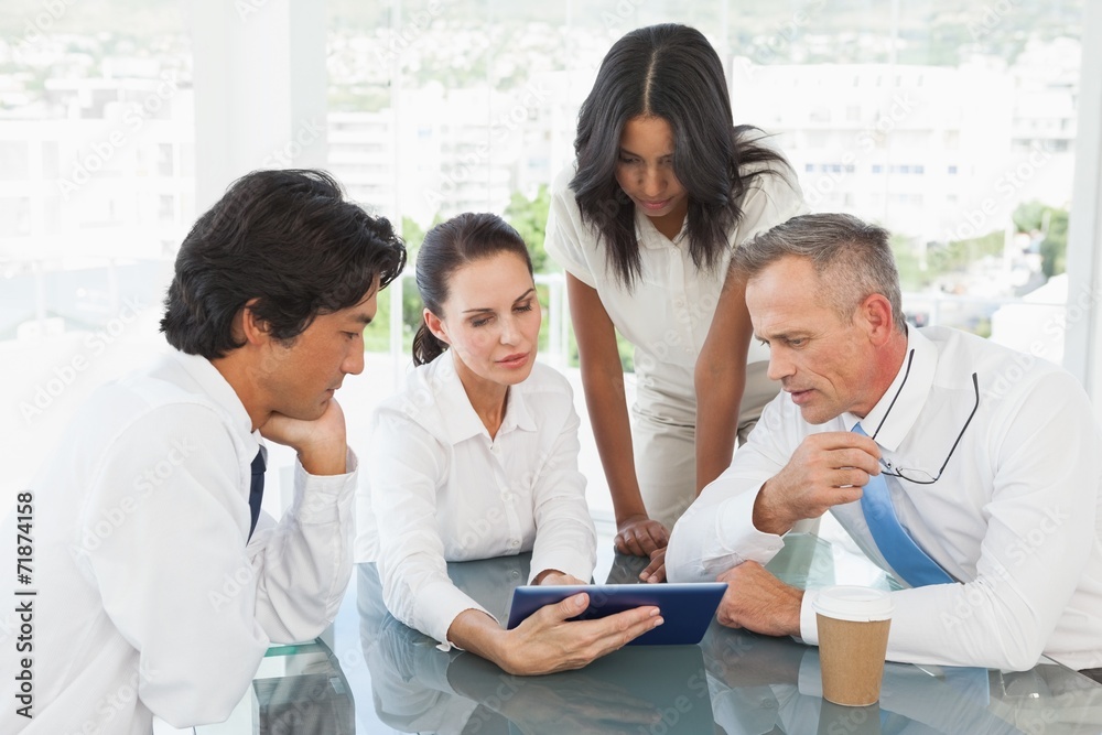 Business team looking at a tablet