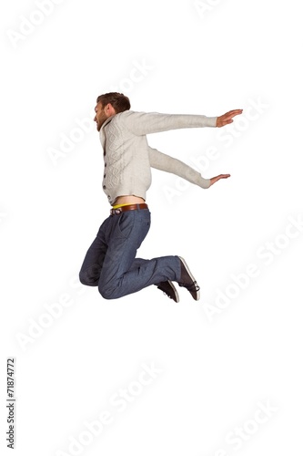 Full length of cheerful young man jumping