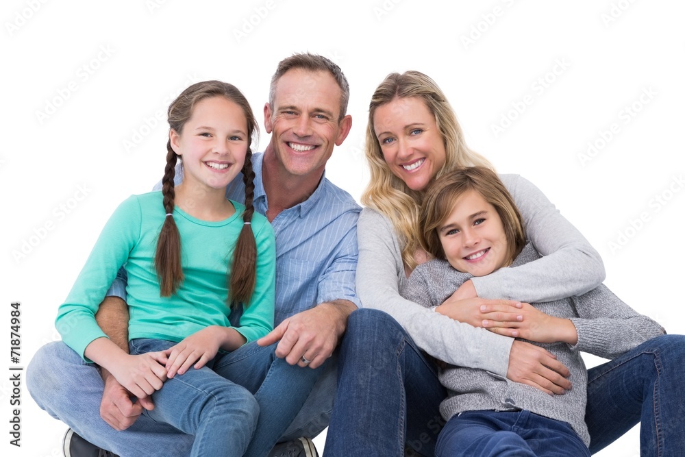 Portrait of a smiling family sitting on the floor Portrait of a smiling family sitting on the floor