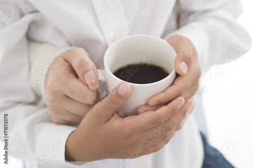 The hands of parents and children with hot coffee