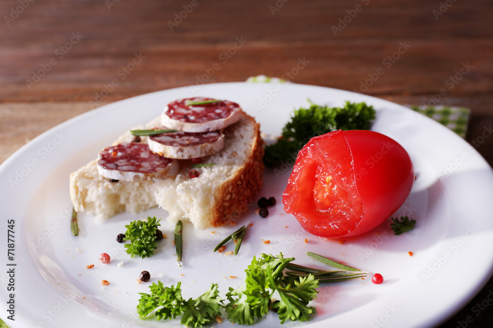 Sandwich with salami on napkin on wooden background Sandwich with salami on napkin on wooden background