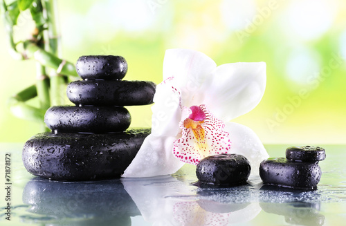 Fototapeta Naklejka Na Ścianę i Meble -  Spa stones and white orchid on table on natural background