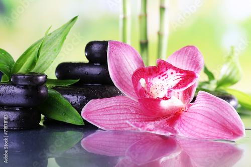 Spa stones, bamboo branches and lilac orchid photo