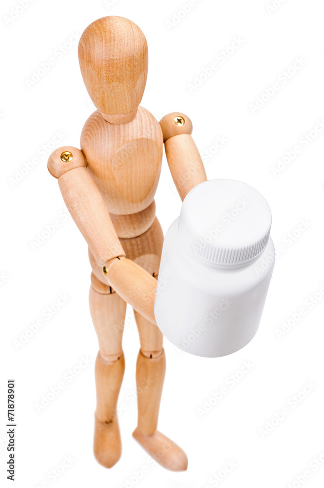 Wooden man hold a medical container with vitamins Wooden man hold a medical container with vitamins