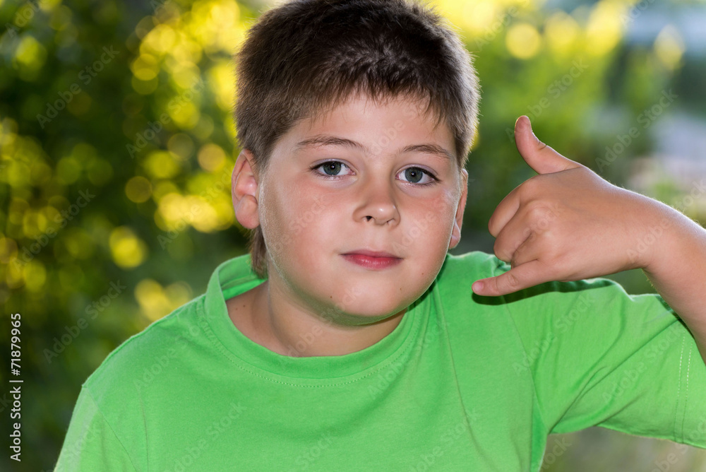 The boy shows gesture call in nature