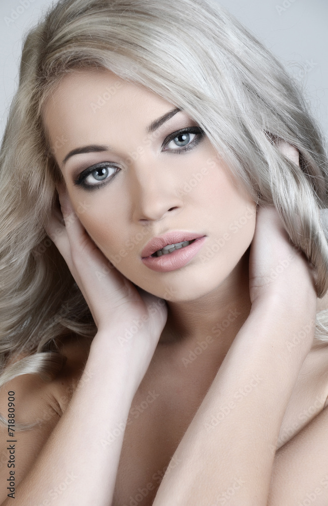 Fototapeta premium Beautiful blond woman with long curly hair
