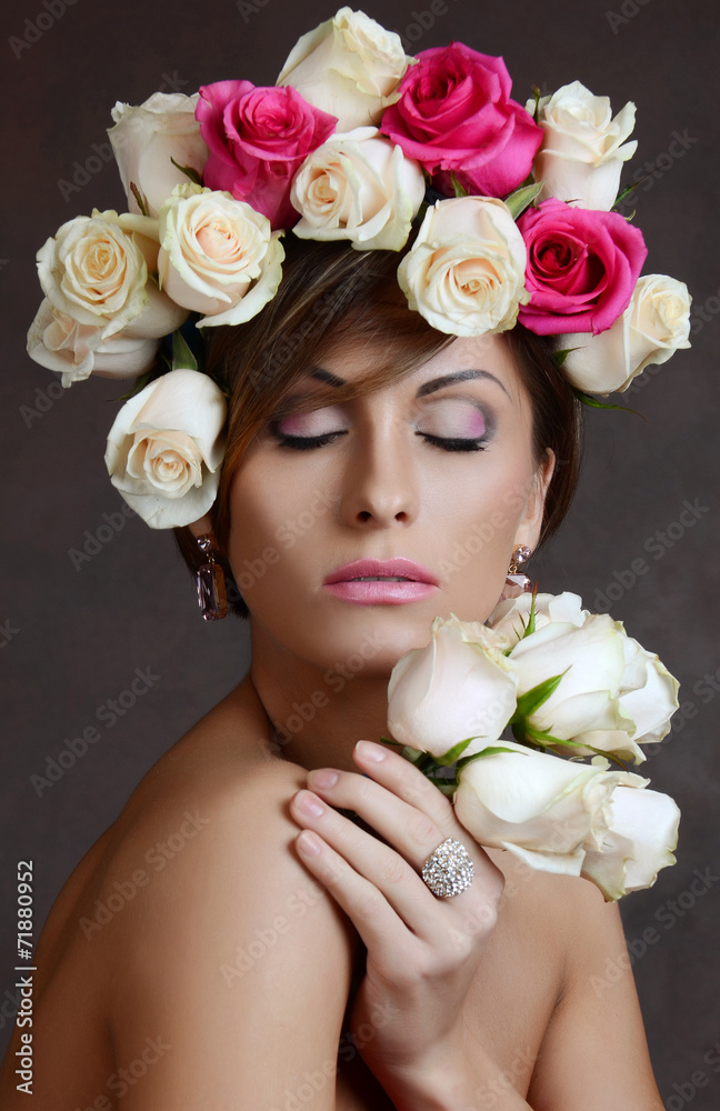 portrait of the  brunette woman with pink flowers in hair