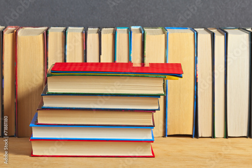 Pile of books on a wooden surface against the background of a nu photo