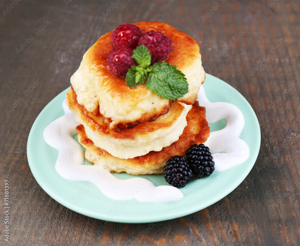 Tasty pancakes with fresh berries, cream and mint leaf Tasty pancakes with fresh berries, cream and mint leaf