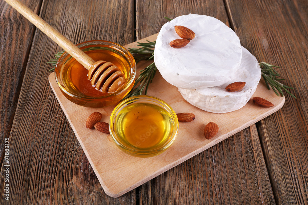 Camembert cheese, honey in glass bowl Camembert cheese, honey in glass bowl